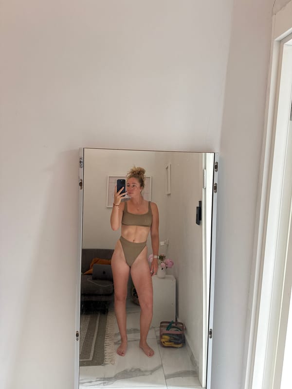 Mirror selfies in a Tel Aviv interior, tan bikini, mid-morning