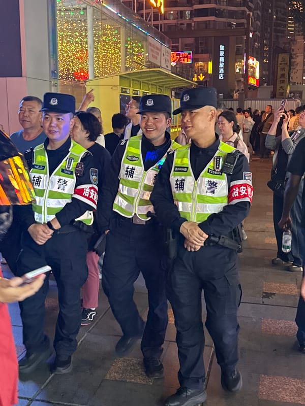 Tourists photograph public art and landmarks in Chongqing district