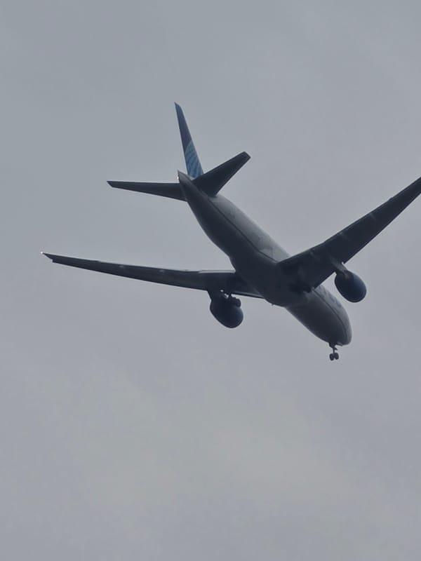 Flat-tired Range Rover, Porsche hauler, and United Airlines approach near Frankfurt