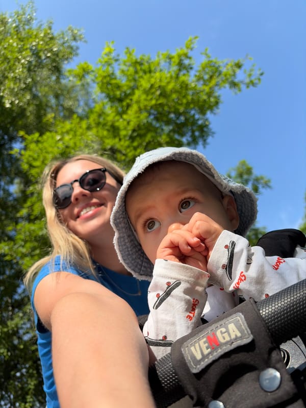 Mother and baby enjoy sunny park outing in Chaikovsky