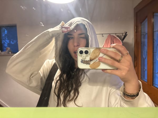 Woman takes selfie in white hoodie in Vancouver indoor location