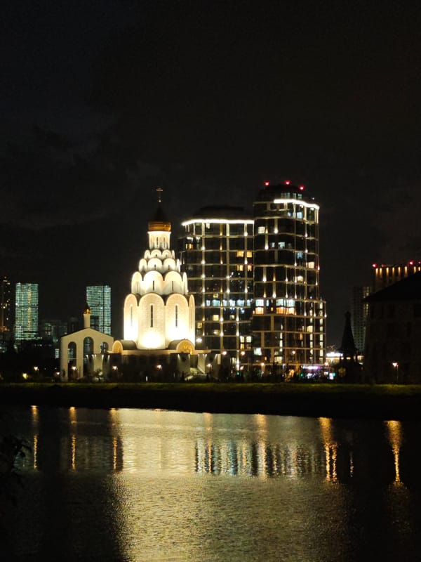 Nighttime waterfront lights reflected across water observed by witness