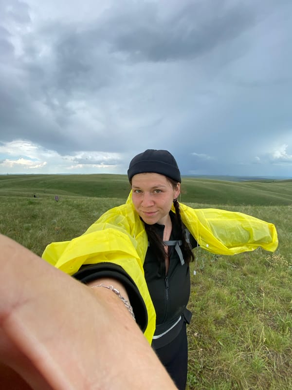 Hiking group explores green hills near Verkhneozernoe, Russia