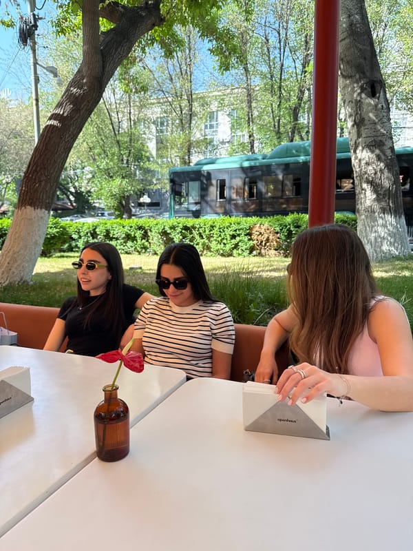 Women share midday meal at flower-decorated Yerevan cafe