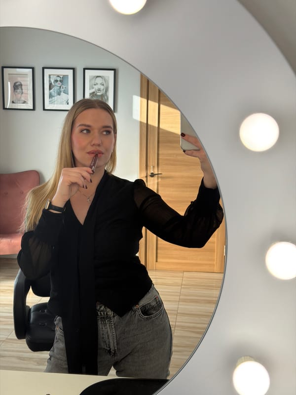 Woman applies makeup at decorated vanity in Riga