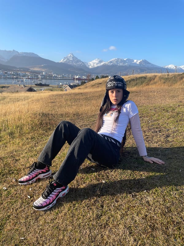 Woman rests on grass in Ushuaia, Argentina