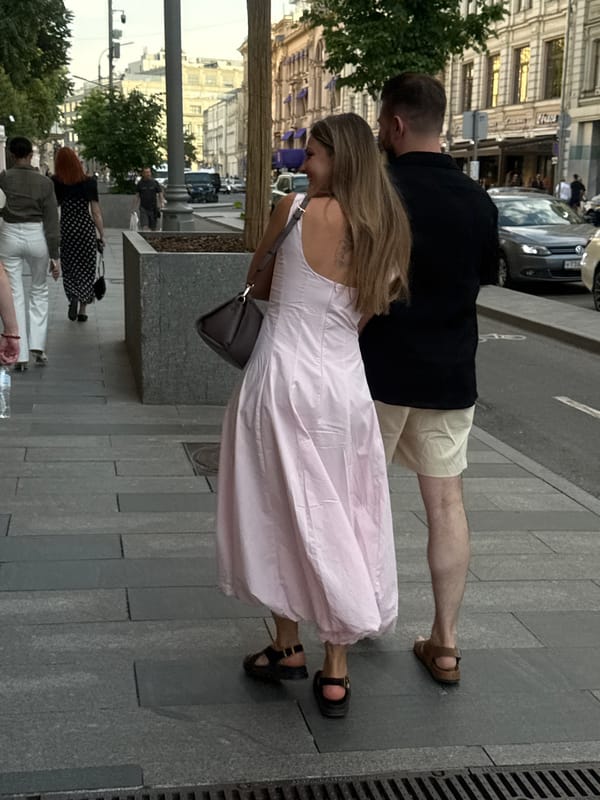 Moscow street life documented with performers, pedestrians, luxury car