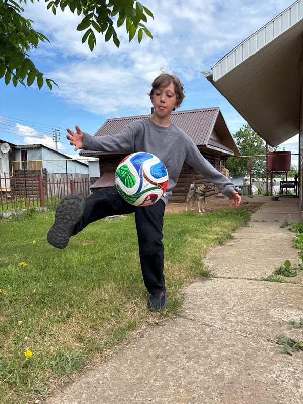 Children play soccer in residential Chaikovsky, Russia neighborhood