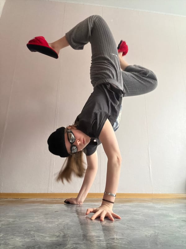 Young person performs handstands and acrobatics indoors in Perm