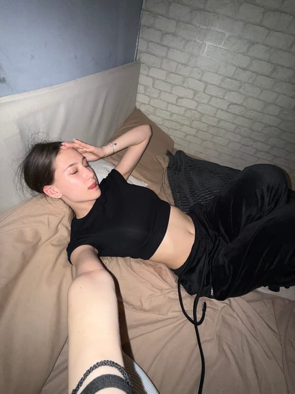 Woman takes mirror selfie in bedroom in Sofia