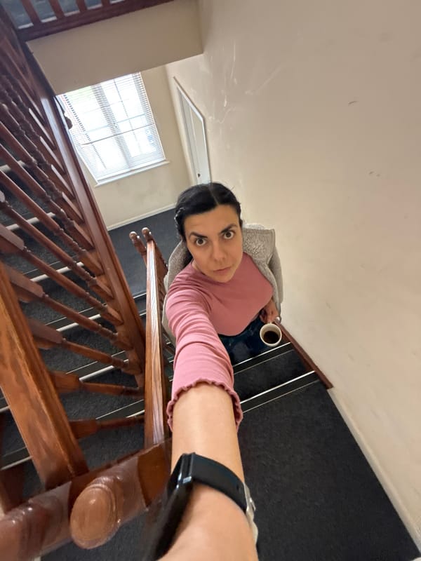 Woman with cup observed on indoor staircase in Great Yarmouth