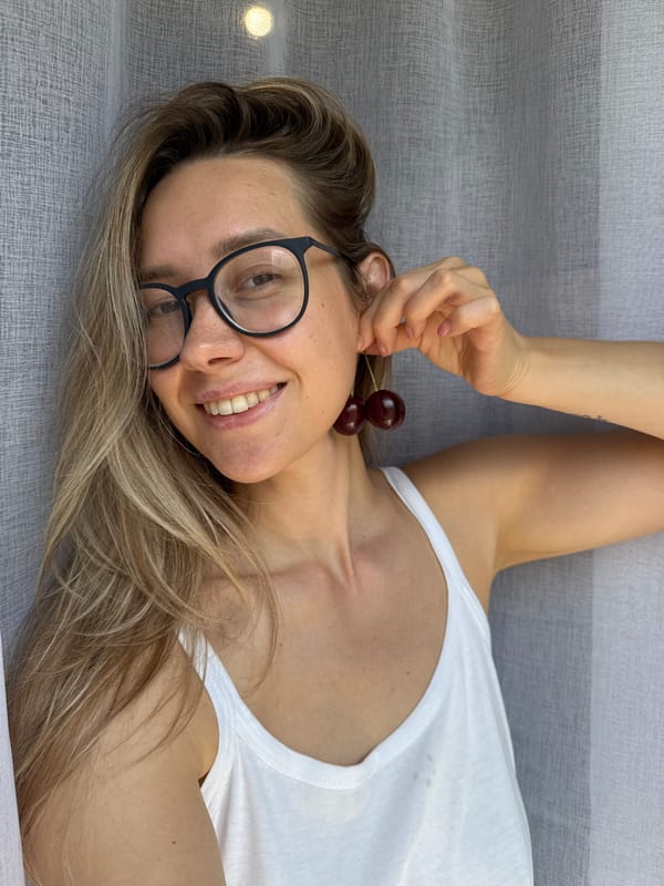 Cherries held up as makeshift earrings in Chaikovsky