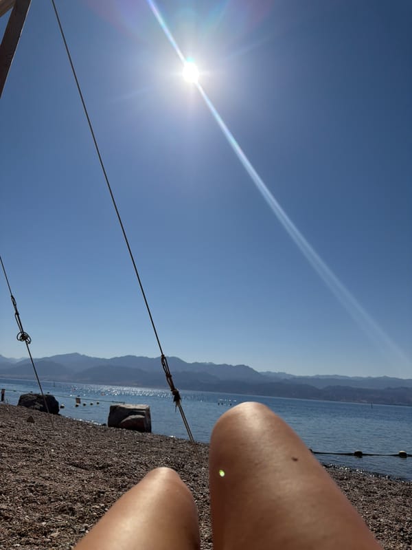 Sunny morning downtime on Eilat's pebble beach by the Red Sea