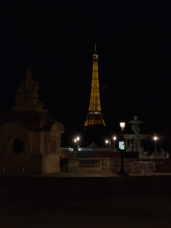 Eiffel Tower glows golden in nighttime Paris photograph