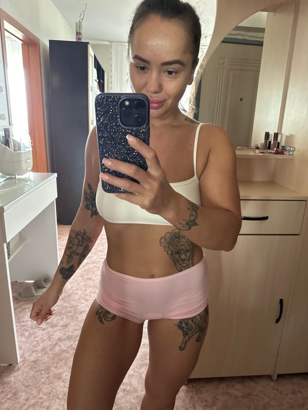 Woman takes mirror selfies in bedroom, Yuzhnouralsk Russia