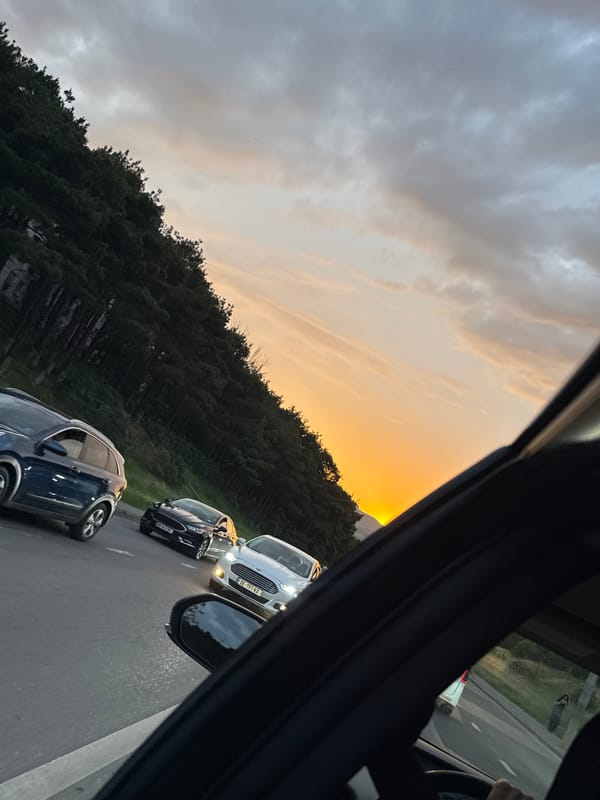 Tbilisi evening commute through a construction-heavy corridor at sunset