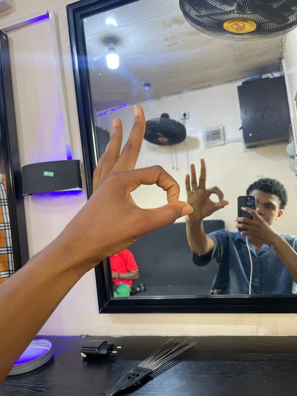 Barber shop visit documented through selfies in Ado, Nigeria
