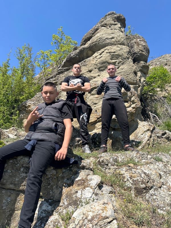 Young men pose at scenic overlook in Goritsa, Bulgaria