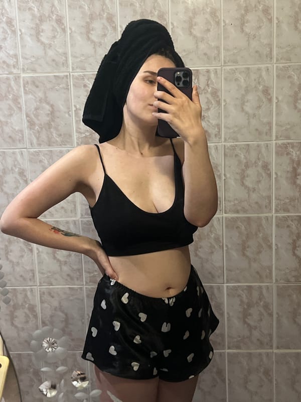 Woman takes mirror selfie in Votkinsk bathroom setting