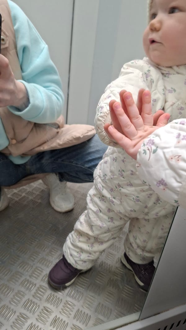 Child and adult captured in reflection image