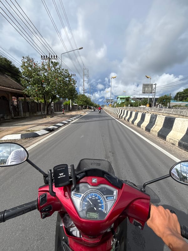 POV riders navigate a construction zone in overcast Rawai
