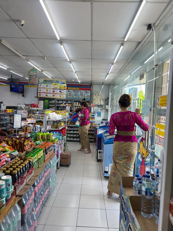 Woman in traditional Balinese dress shops at Sukawati convenience store