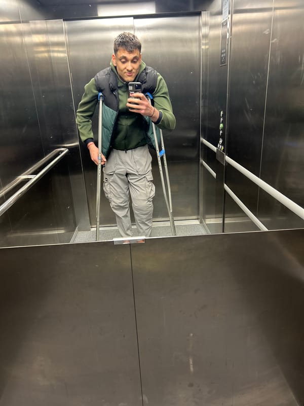Man with crutches uses phone in Varna elevator