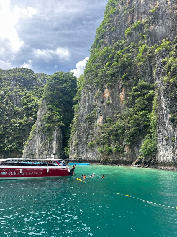 Tour boats and swimmers at Koh Phi Phi Leh's limestone coves