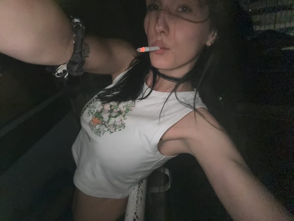 Person smoking cigarette outdoors at night captured in photos