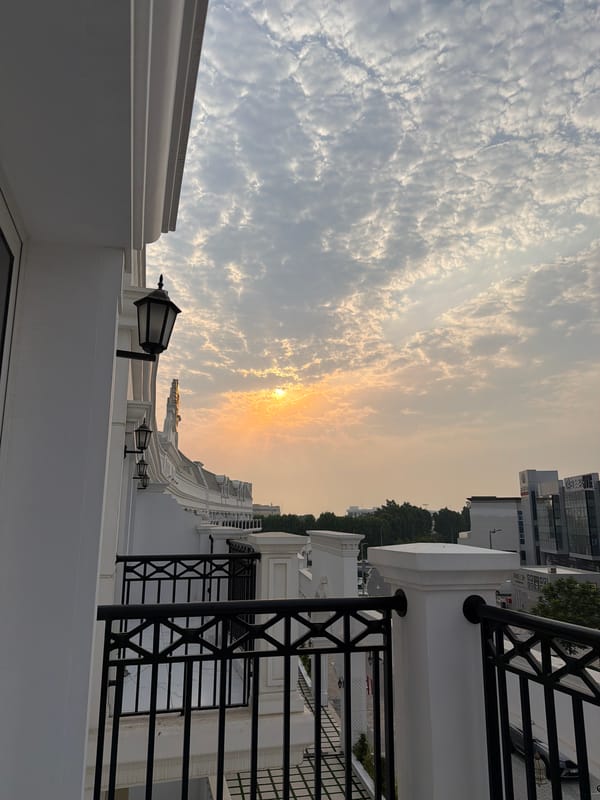 Dubai balcony overlooks cityscape at cloudy sunset