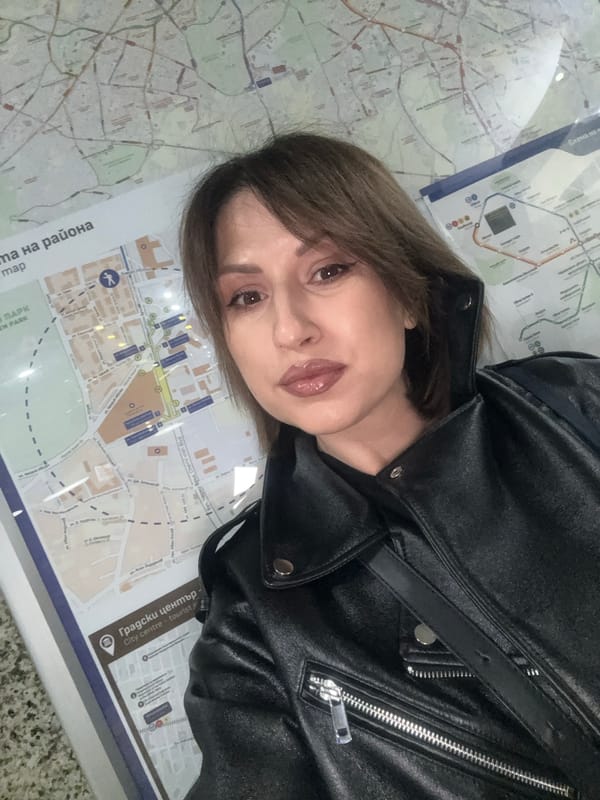 Tourist takes selfies, uses city map in Sofia