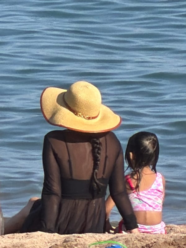 Sun, sand, and paddleboards on a calm beach day