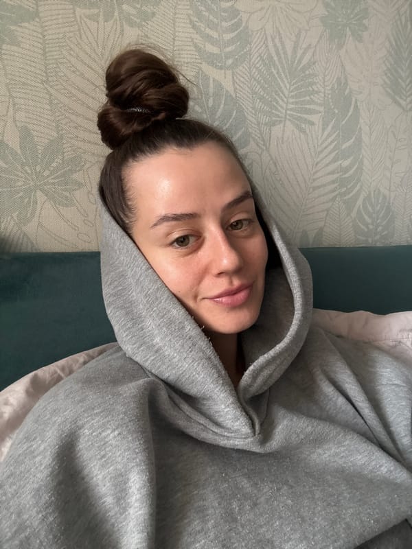 Woman in gray hoodie observed resting in Krasnoyarsk