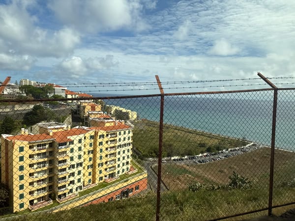 Coastal overlook with yellow building documented in Funchal, Portugal