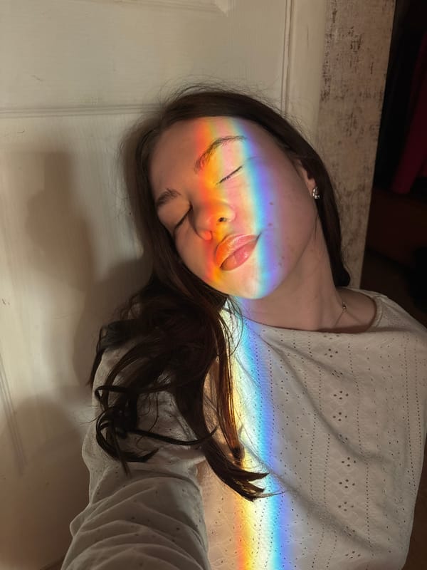 Woman illuminated by rainbow light observed in Perm