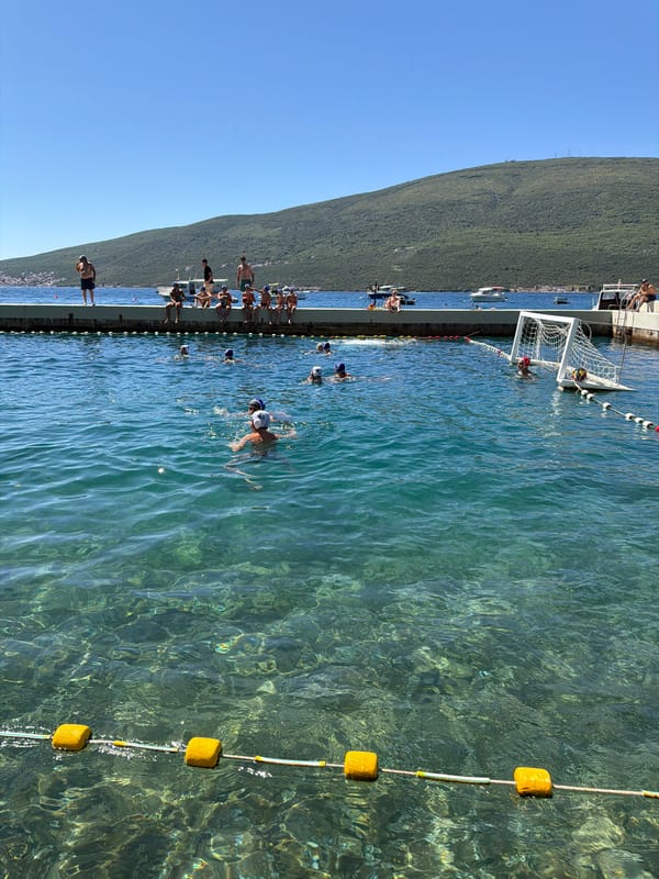 Water polo match in a scenic Montenegrin coastal bay