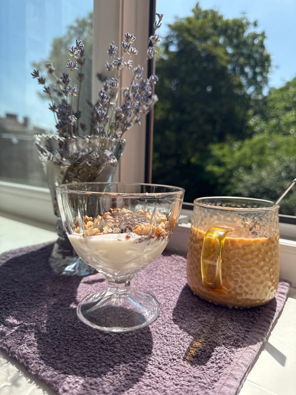 Sunny windowsill breakfast with yogurt, coffee, and dried lavender