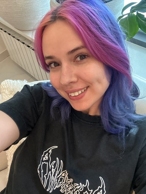 Woman with colorful split-dyed hair takes selfie in Zagreb