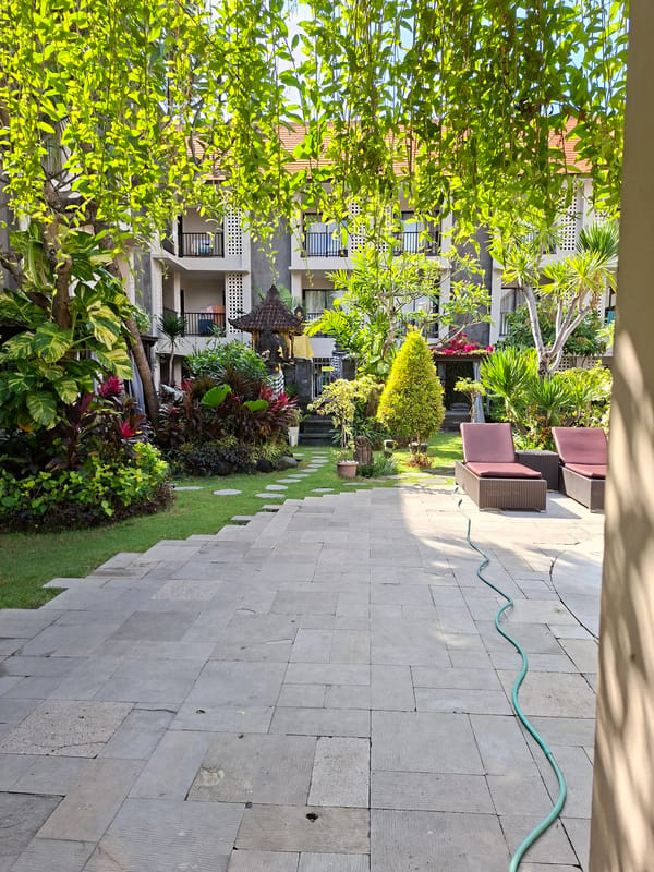 Kuta resort grounds: pool, courtyard, and walkways