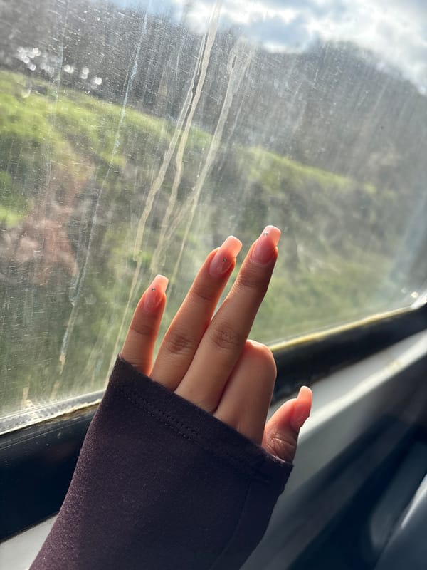 Hand with manicured nails pressed against window in Bulgaria