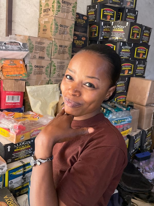 Women photographed in Jos shop setting during midday