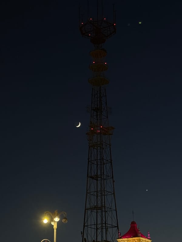 Evening scenes documented across illuminated Minsk under crescent moon