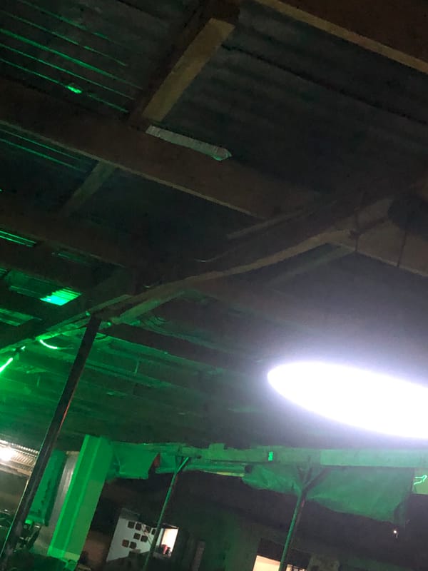 Evening documented between outdoor pool hall and LED-lit residence