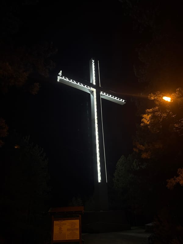 Illuminated cross captured at night in Blagoevgrad, Bulgaria