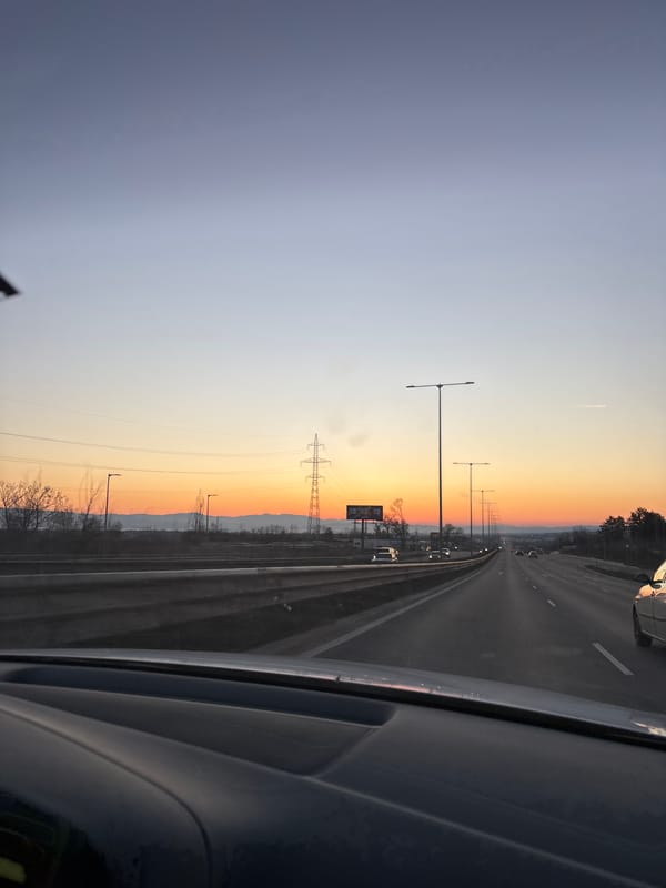 Highway traffic observed near Sofia with directional signage at dusk