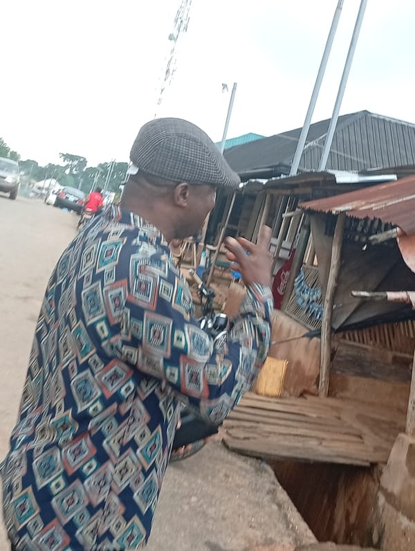 Street activity near a roadside market, mid-afternoon