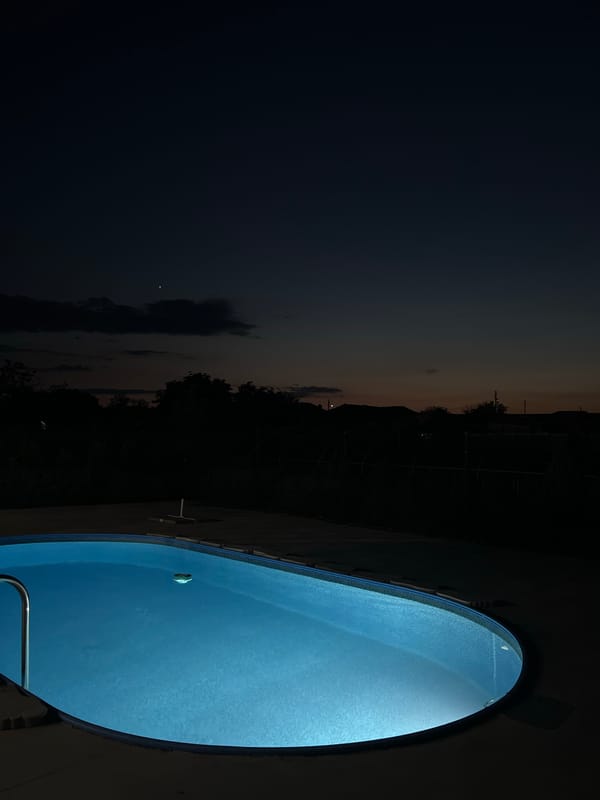 Summer evening in Lozen: glowing pool, stork on a pole