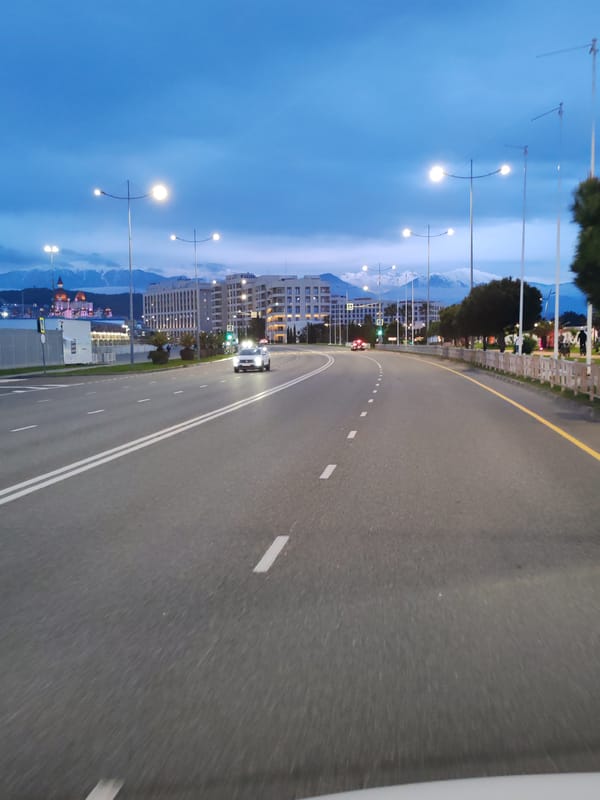 Evening traffic documented on urban road during twilight