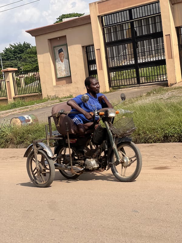 Man on tricycle observed outside building in Onitsha