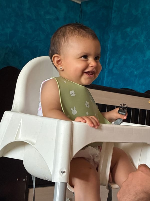 Baby in high chair, mixed moods, Montana, Bulgaria